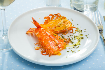 Seafood dish. Delicious spicy grilled cut shrimps on white dish..