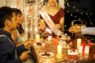 Group of Multiethnic Asian Friends Having Fun Celebrating Birthday Girl With Sparklers