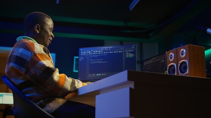 Black software engineer writes complex binary code scripts on computer, cybersecurity. Teleworking...
