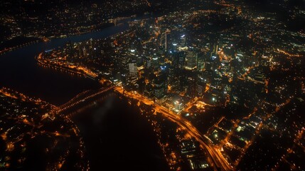 Aerial view of a city skyline illuminated at night, highlighting urban life and infrastructure.