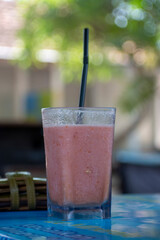 A glass of red guava juice. Food and beverage outdoor restaurant concept.