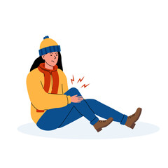 Obraz premium Young woman sitting on the ground, holding her knee in pain during winter in a cozy outfit