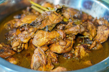 Close-up view of a rich and flavorful Indonesian chicken stew. The chicken is tender and cooked in a flavorful sauce. Aromatic and Savory Chicken Stew.