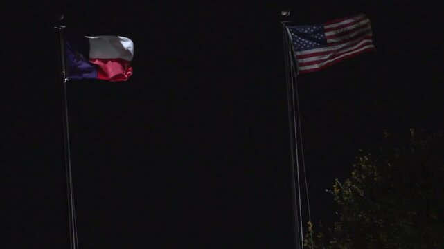 USA and Texas Flag waving at night in Austin, Texas 11/28/2024