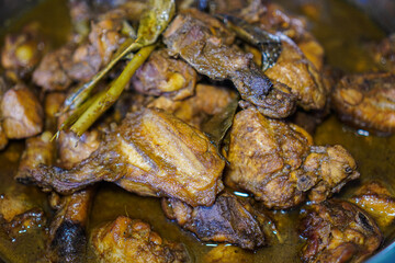 Close-up of succulent braised chicken pieces in a rich, dark brown sauce. A delectable culinary delight. Delicious Braised Chicken in Rich Brown Sauce.