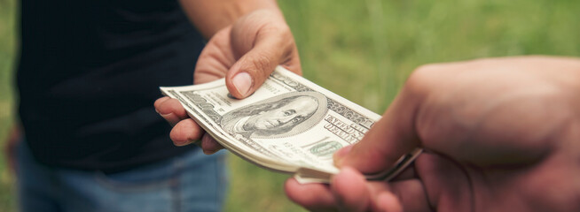 Close up hands giving money bribe payment. Hands holding dollar bill bribery financial economy...