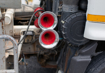 The red truck's air horn is mounted on the side.