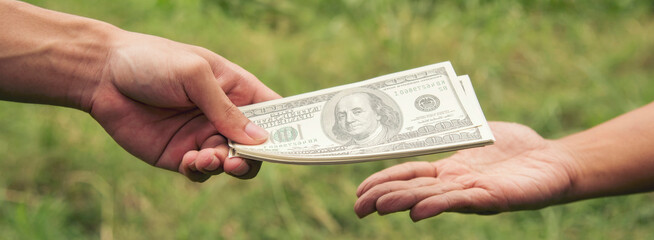 Close up hands giving money bribe payment. Hands holding dollar bill bribery financial economy...