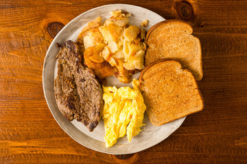 Steak, eggs, potatoes and toast