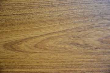 A close-up shot of a wooden texture background, showcasing a warm, natural wood grain pattern with subtle light and dark variations. Ideal for design, product display, or rustic themes.