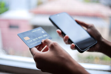 Portrait of Hand Holding Credit Card and Smartphone Shopping Online Using Internet