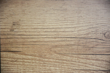 Fototapeta premium A close-up shot of a wooden texture background, showcasing a warm, natural wood grain pattern with subtle light and dark variations. Ideal for design, product display, or rustic themes.