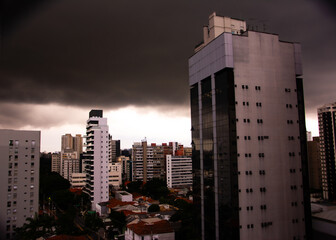 A storm brewing in the skies over São Paulo, Brazil. Dark clouds and lightning fill the sky, creating an intense, dramatic scene.