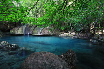 Fototapeta premium Tropical landscape waterfall with beautiful emerald lake and rocks in wild jungle forest. Erawan National park, Kanchanaburi Province, Thailand 