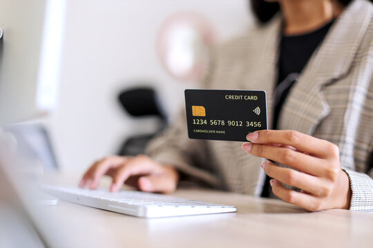 Businesswoman Securely Enters Payment Details Online With Credit Card And Computer, Showcasing The Convenience of E Commerce in Today's Digital Age

