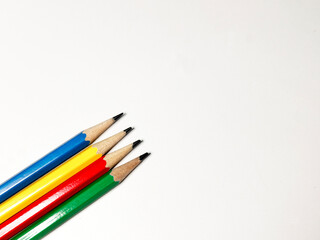 blue, yellow, red, and green pencils on a white background