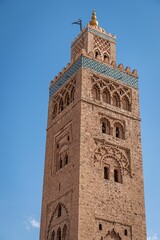 Fototapeta premium Koutoubia Mosque tower in Marrakech, Morocco against a clear blue sky.