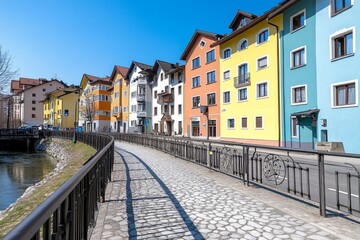 Fototapeta premium A scenic riverside city with colorful houses, quaint bridges, and cobblestone streets