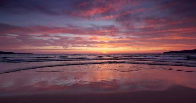 Tropical beach shore and beautiful sunrise over the sea horizon and calm ripple waves