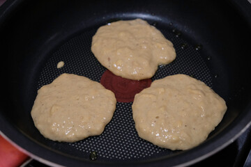 Making gluten free homemade pancake made from mocaf flour on a white plate.