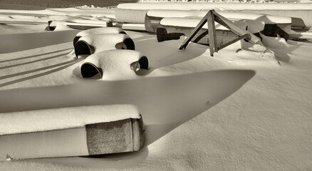 A repair company servicing main pipelines, under the snow lie pipes and large diameter pipe...