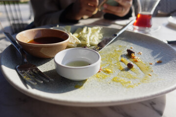 An empty dirty plate with a fork.