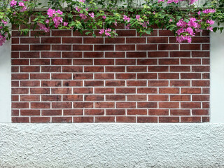 white wall with flower at the top and red brick in the middle
