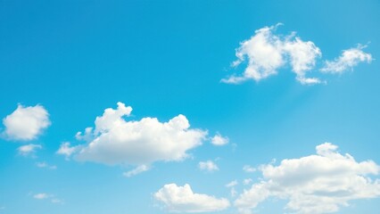 Soft white clouds against a brilliant clear blue sky with gentle breeze, bright blue sky, white clouds, weather conditions., serene landscape