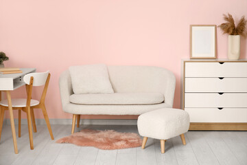 Modern interior of living room with white sofa and footrest