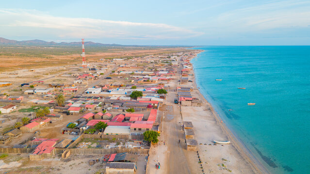 Aerial View of Cabo de la Vela, La Guajira, Colombia: Vibrant Coastal Community Against Scenic Desert Landscape