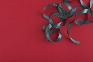 Green ribbons on red background