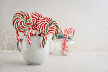Christmas candy canes,  lollipops and marshmallows in a mug