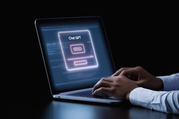 Person using ai chatbot interface on laptop in dimly lit environment