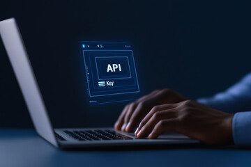 Api development on laptop - caucasian male hands typing in low light
