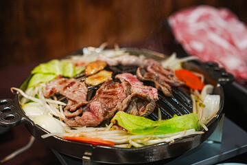 Grilled Meat and Vegetables on a Tabletop Grill