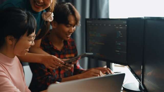 Slow motion back end software developer engineer for computer programming working together on debugging writing computing code, solving complex algorithms display on monitor in office. Burgeoning