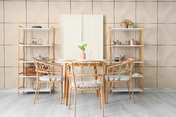 Interior of room with dining table, shelf units and folding screen