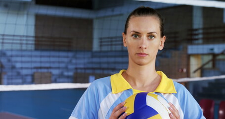 Portrait of female player holding volleyball in the court 4k