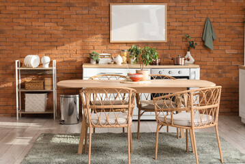 Interior of kitchen with dining table, shelf unit and blank frame