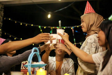 Group of Friends Toasting Drink Celebrating Birthday Outdoors at Night