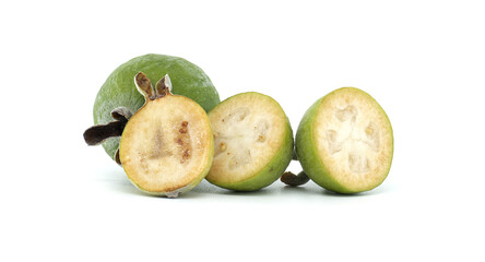 Close-up of a whole feijoa fruit and a halved section showcasing its juicy texture