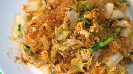 stir fried sukiyaki with egg and pork on white plate