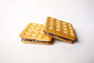 Sandwich biscuits with chocolate filling on white background