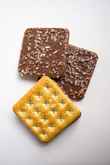 Chocolate biscuits with coconut sprinkles on white background