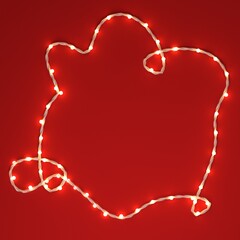 Christmas greeting card template, banner mock up with copy space, space for text. Christmas festive lights garland on red background. Holiday background, beautiful fairy lights string party backdrop