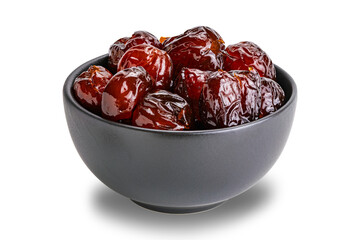 Pile of sweet pitted chinese jujube fruit preserved in syrup in black ceramic bowl isolated on white background with clipping path.