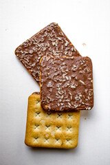 Sandwich biscuits with chocolate filling and coconut sprinkles on white background
