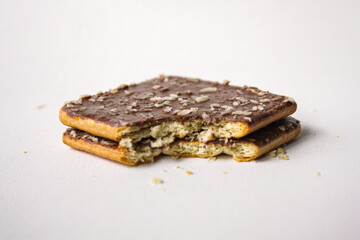 Bitten chocolate sandwich biscuit on white background