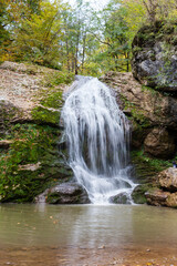 a waterfall in the summer, rushing streams and jets of water and turned into a huge shower of water