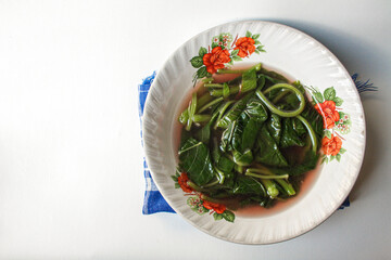 Sayur Bening Bayam Merah or Red Spinach Clear Soup served in a white bowl